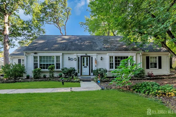 a front view of house with a garden