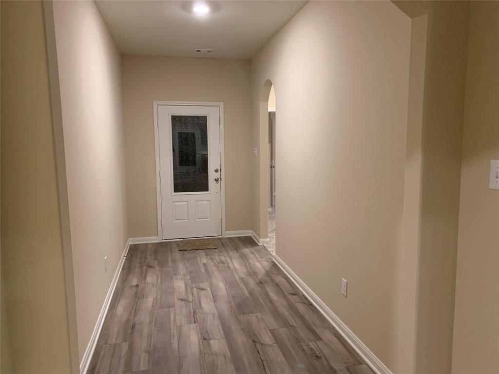 304 Wandering Stream Way Princeton, TX 75407 - Photo 11 of 13 a view of a hallway with wooden floor
