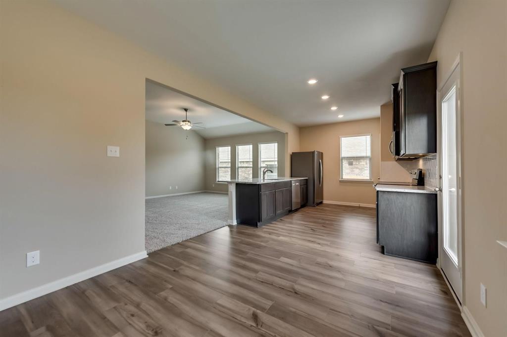 304 Wandering Stream Way Princeton, TX 75407 - Photo 4 of 13 a view of a kitchen with wooden floor