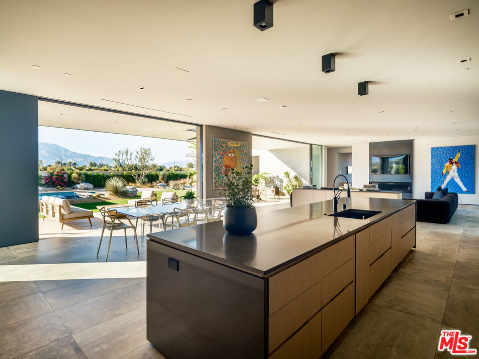 3 Echo Lane Rancho Mirage, CA 92270 - Photo 12 of 39 a dining hall with stainless steel appliances granite countertop a stove and a view of living room