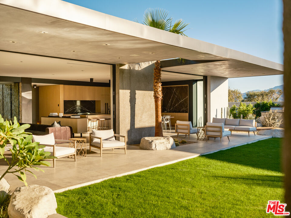 3 Echo Lane Rancho Mirage, CA 92270 - Photo 17 of 39 a living room with patio furniture and a large window