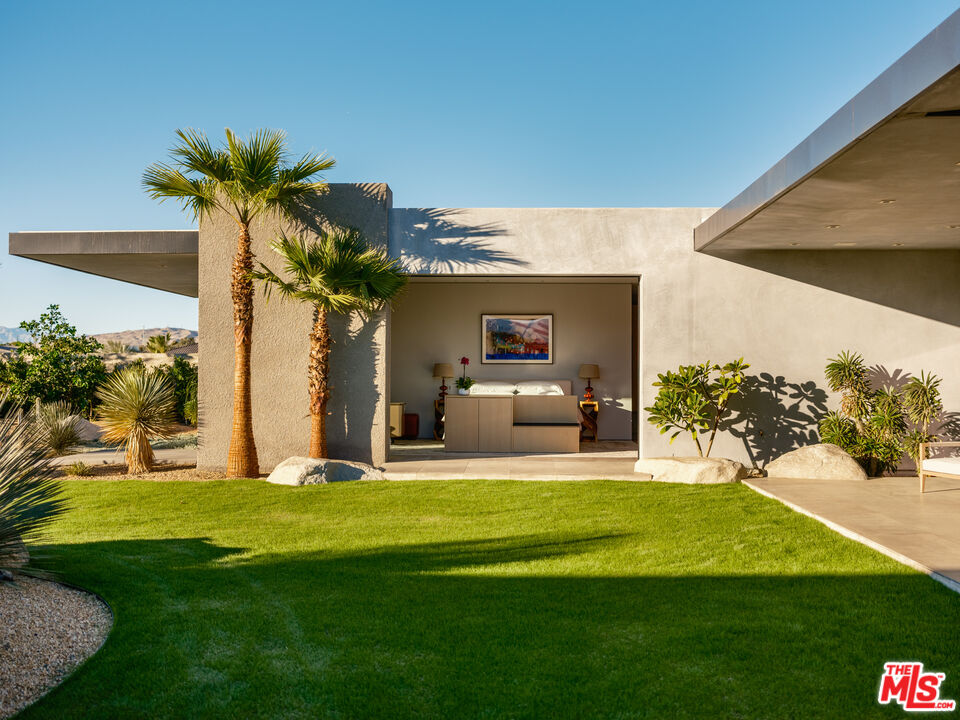 3 Echo Lane Rancho Mirage, CA 92270 - Photo 19 of 39 a view of a house with a big yard potted plants and a palm tree