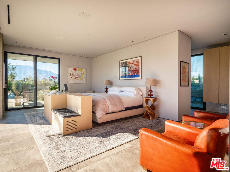 3 Echo Lane Rancho Mirage, CA 92270 - Photo 20 of 39 a bedroom with bed couch and window