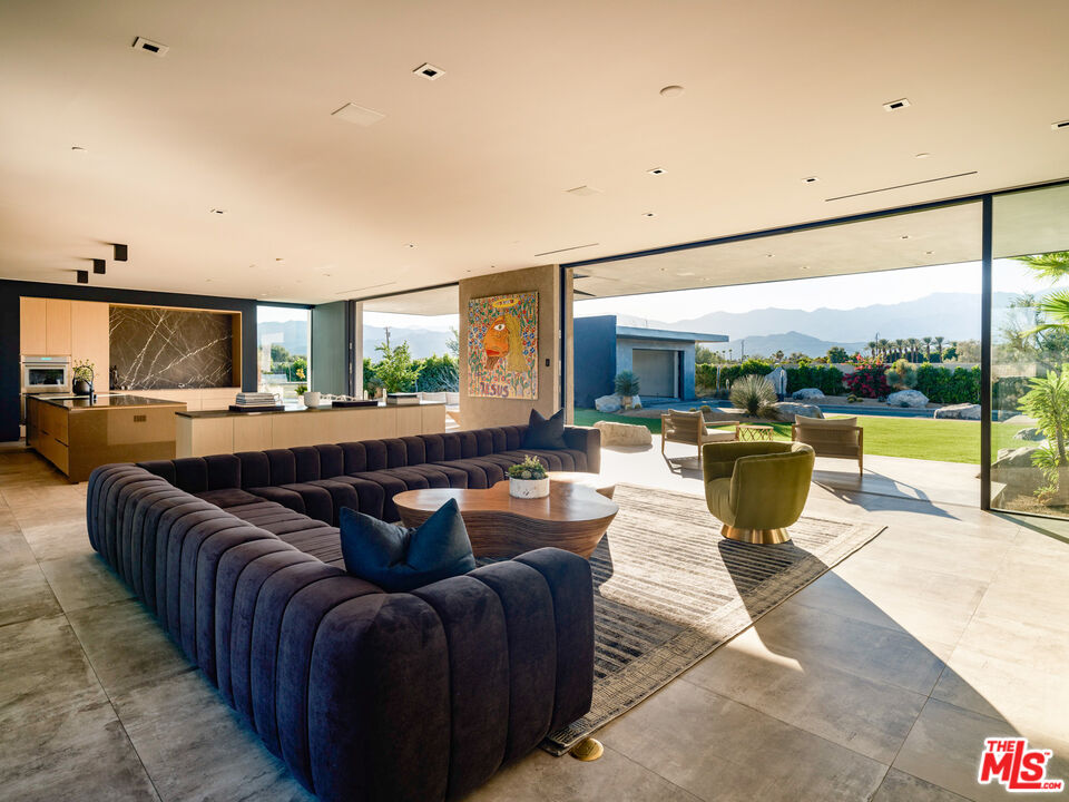 3 Echo Lane Rancho Mirage, CA 92270 - Photo 3 of 39 a living room with couches a coffee table and kitchen view
