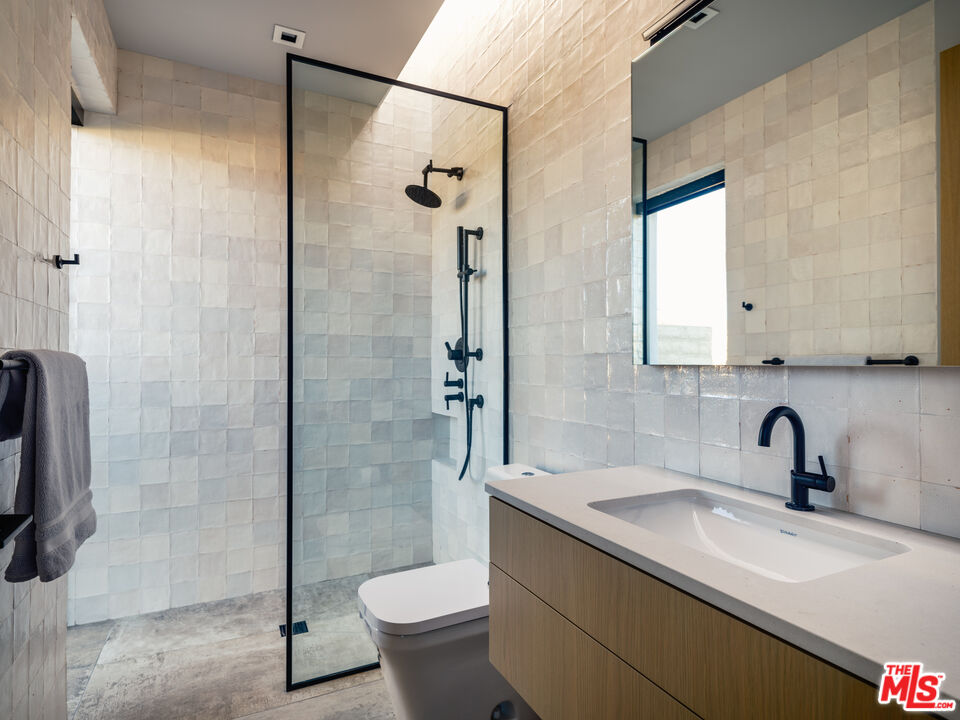 3 Echo Lane Rancho Mirage, CA 92270 - Photo 27 of 39 a bathroom with a sink toilet and shower