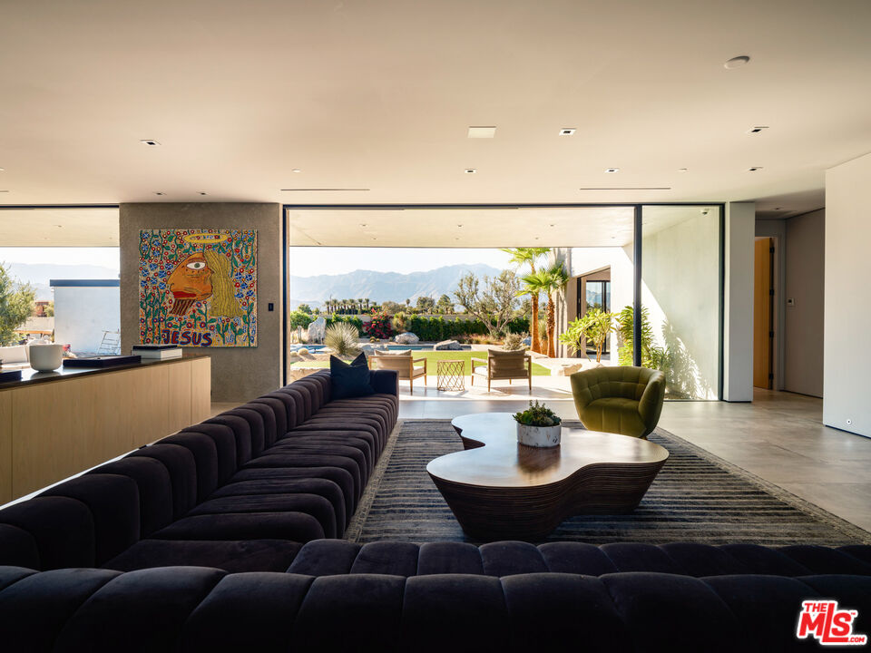 3 Echo Lane Rancho Mirage, CA 92270 - Photo 4 of 39 a living room with patio couches and a dining table with garden view
