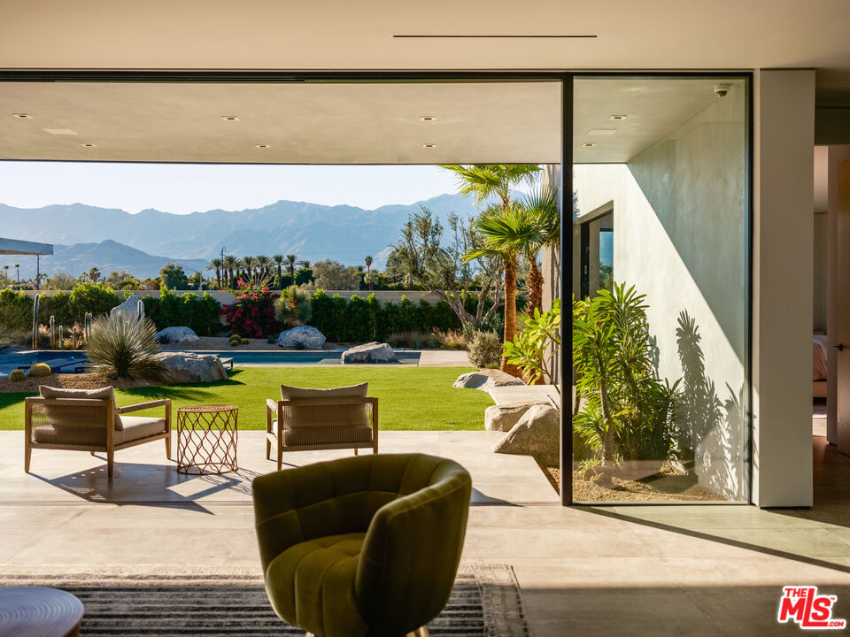 3 Echo Lane Rancho Mirage, CA 92270 - Photo 5 of 39 a view of a swimming pool with a couches in a patio