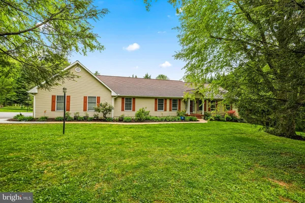 a front view of a house with a garden and porch