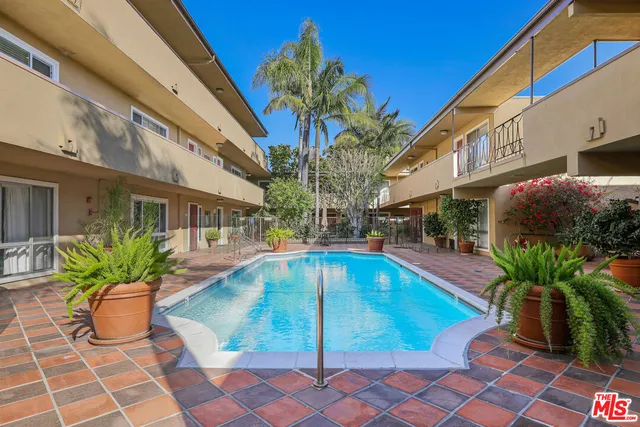 a view of a patio with swimming pool table and chairs