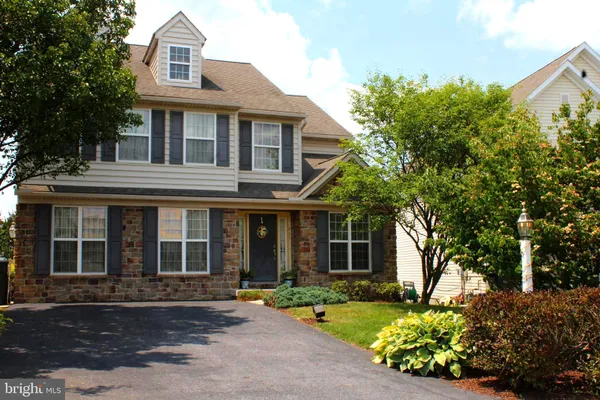 a front view of a house with a garden and porch