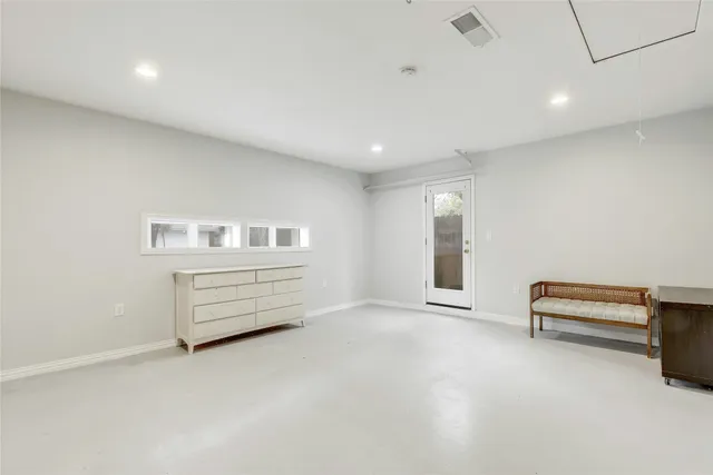 an empty room with furniture and white walls