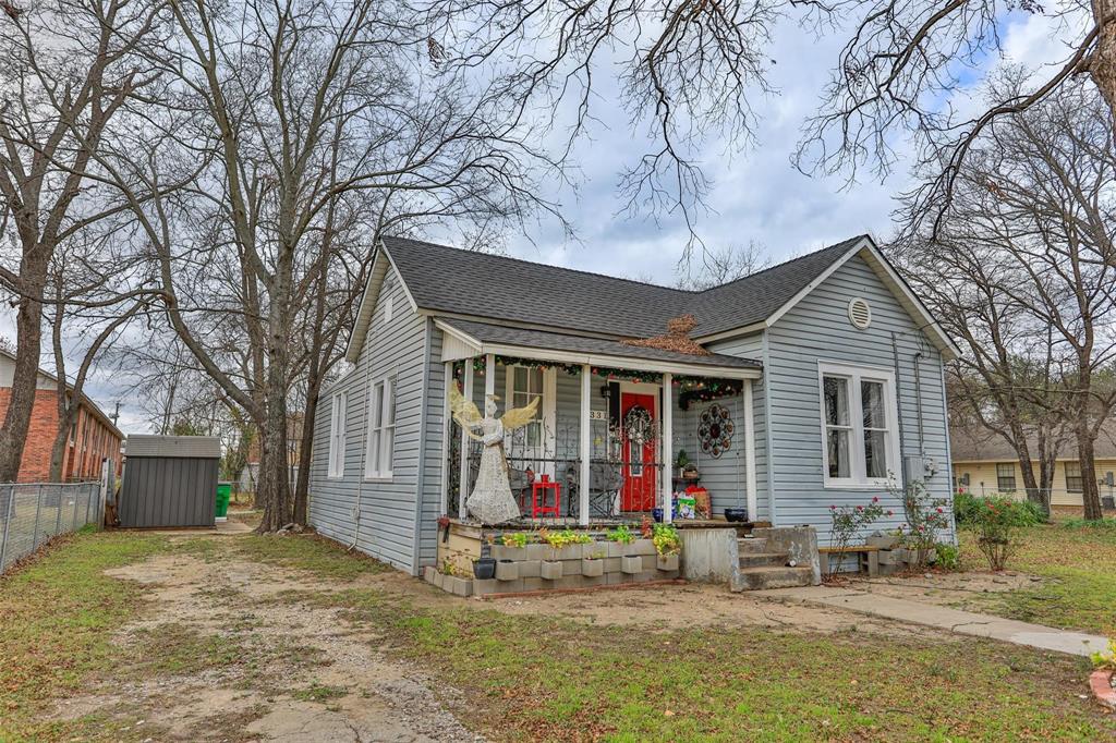 a view of a house with a patio and a yard