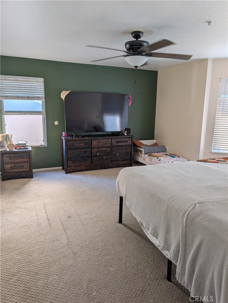 7397 McClellan Court Fontana, CA 92336 - Photo 9 of 14 a bedroom with a bed and a television