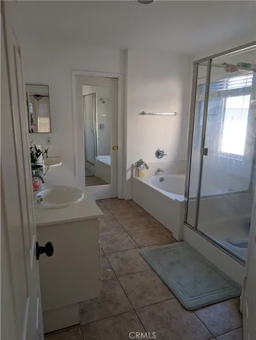 a bathroom with a tub shower and mirror