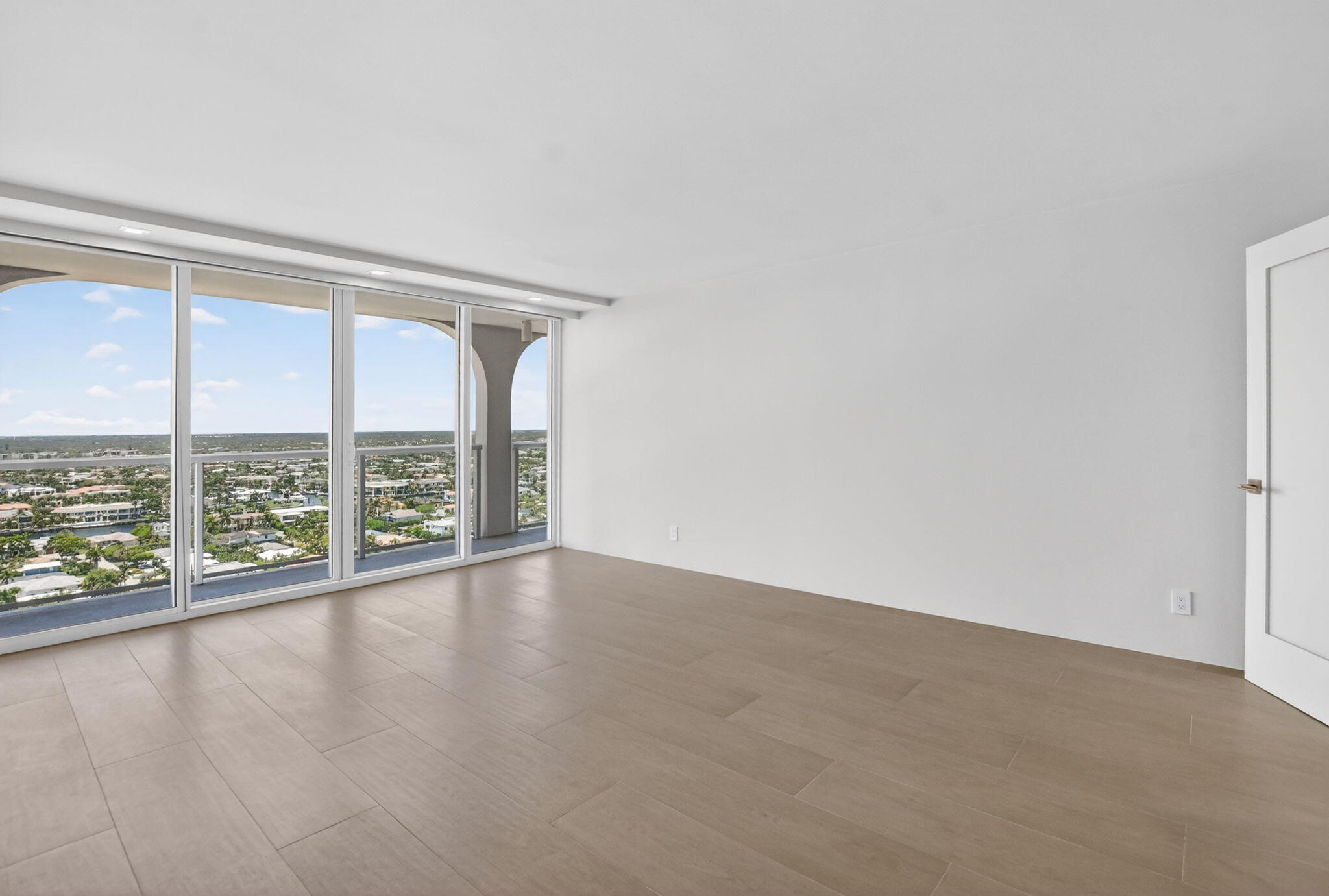 2800 South Ocean Boulevard, Unit 23C Boca Raton, FL 33432 - Photo 27 of 50 an empty room with wooden floor and windows
