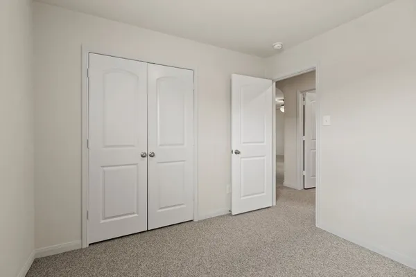 a view of an empty room and closet area