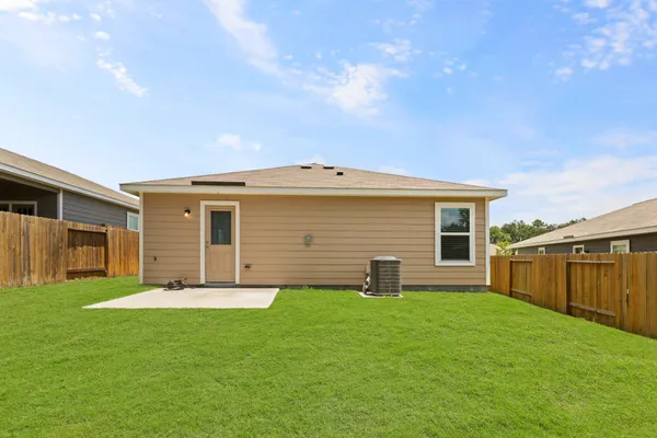 a backyard of a house with table and chairs