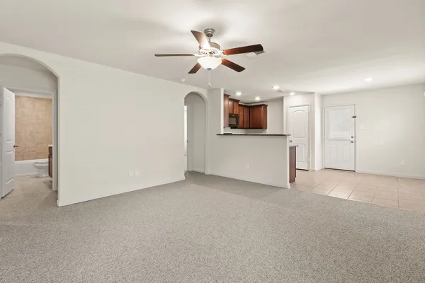 a view of a kitchen with a sink and a ceiling fan