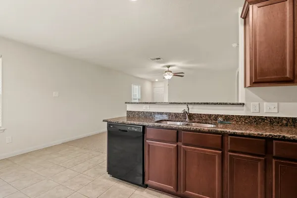a sink with granite countertop a sink and cabinets