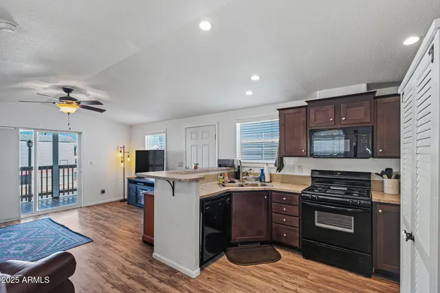 a kitchen with a stove a sink and a microwave