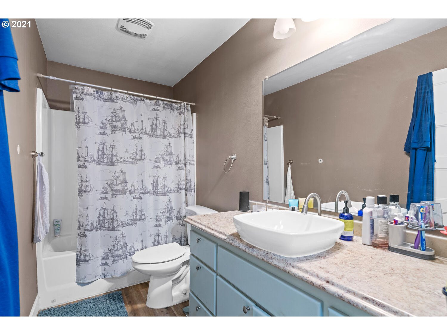 2110 Pioneer Street Ridgefield, WA 98642 - Photo 20 of 32 a bathroom with a granite countertop sink toilet a mirror and shower