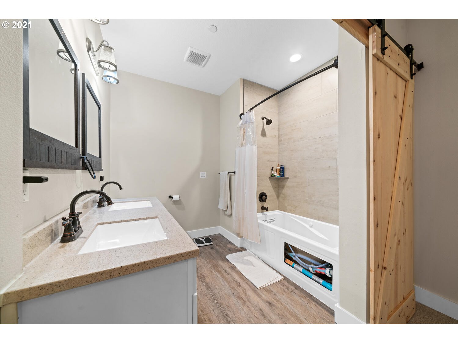 2110 Pioneer Street Ridgefield, WA 98642 - Photo 9 of 32 a bathroom with a sink a mirror a vanity and a shower