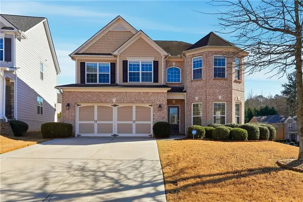 a front view of a house with a yard