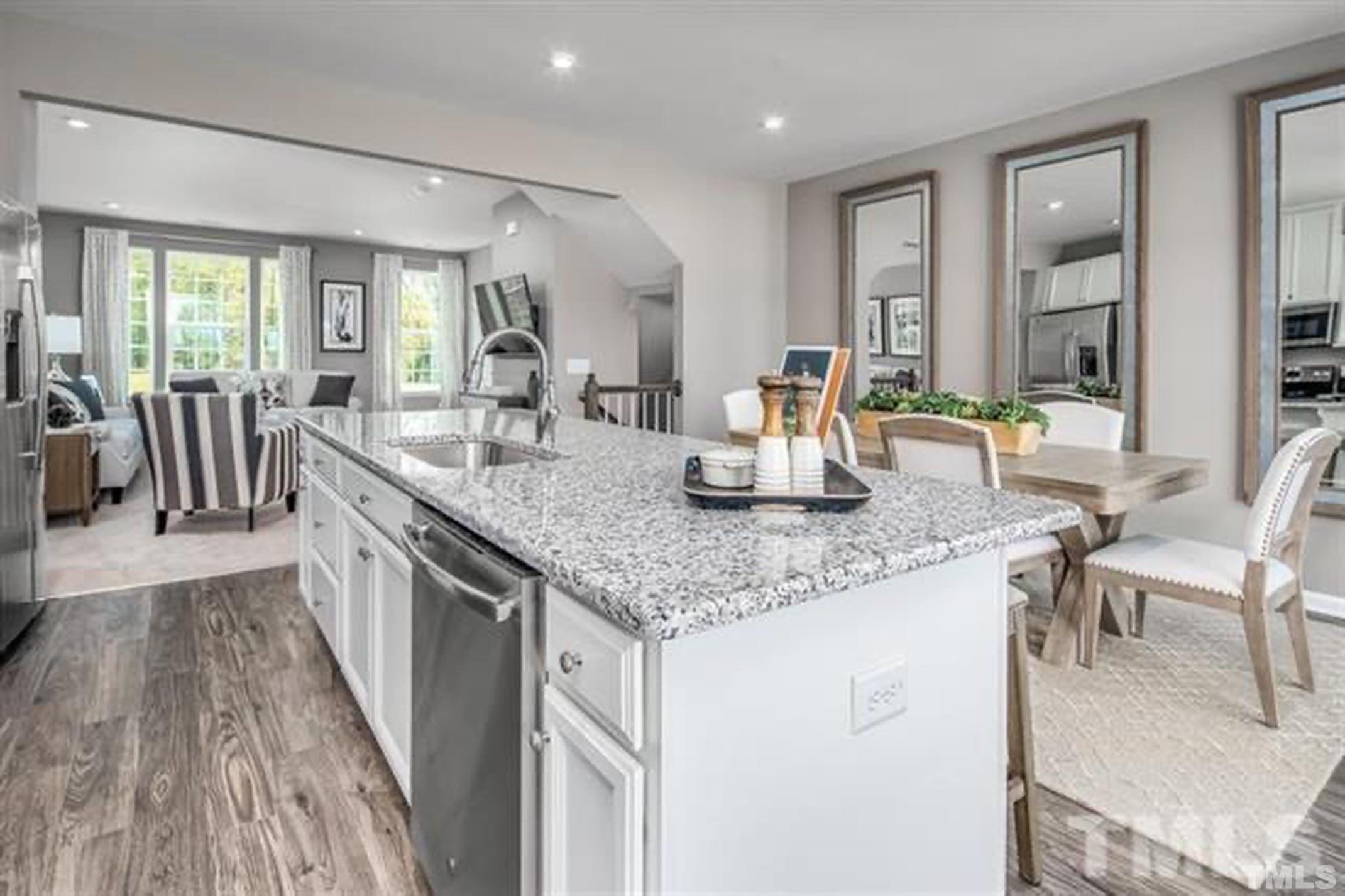 6432 Pathfinder Way, Unit 1009G Raleigh, NC 27616 - Photo 1 of 8 a dining hall with stainless steel appliances granite countertop a sink and wooden floor