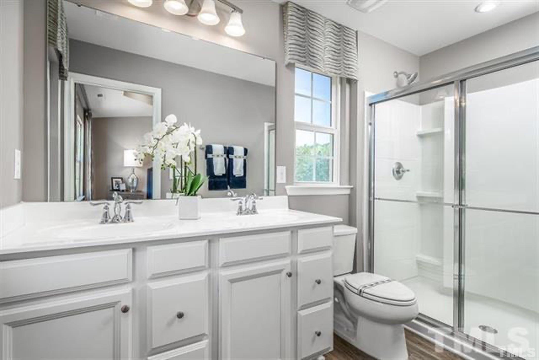 6432 Pathfinder Way, Unit 1009G Raleigh, NC 27616 - Photo 5 of 8 a bathroom with a sink toilet and shower