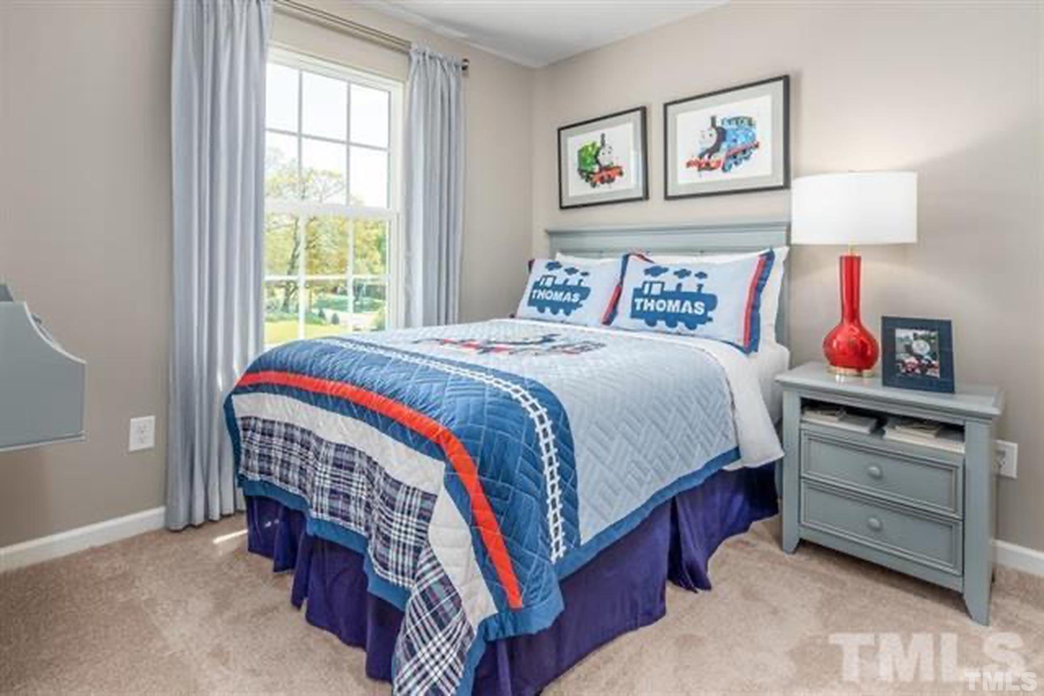 6432 Pathfinder Way, Unit 1009G Raleigh, NC 27616 - Photo 7 of 8 a bedroom with bed and a window