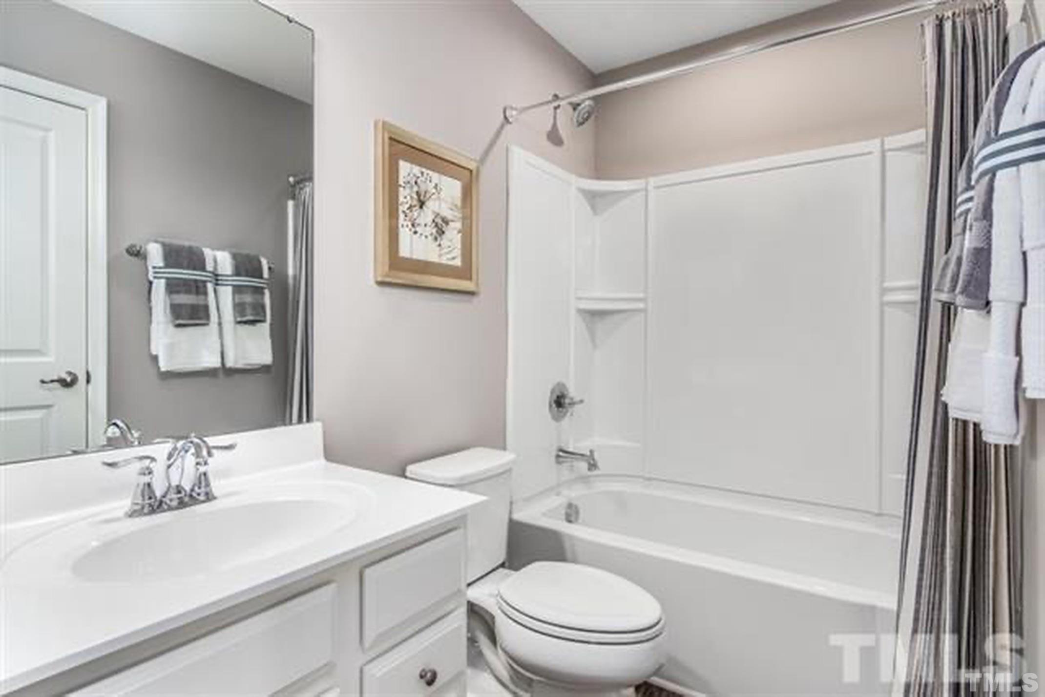 6432 Pathfinder Way, Unit 1009G Raleigh, NC 27616 - Photo 8 of 8 a bathroom with a sink toilet and shower