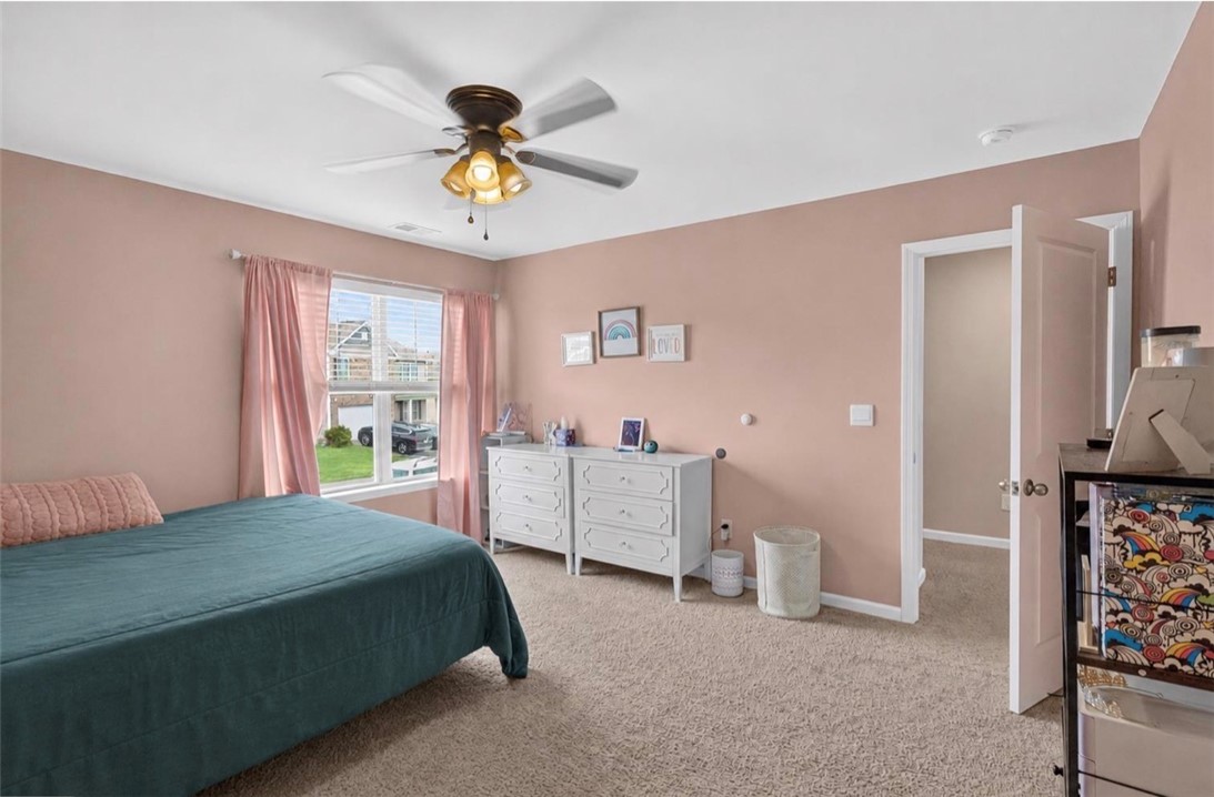 213 Millhone Way Pendleton, SC 29670 - Photo 15 of 25 A well-lit bedroom provides comfort and style, featuring soft carpeting and a ceiling fan.