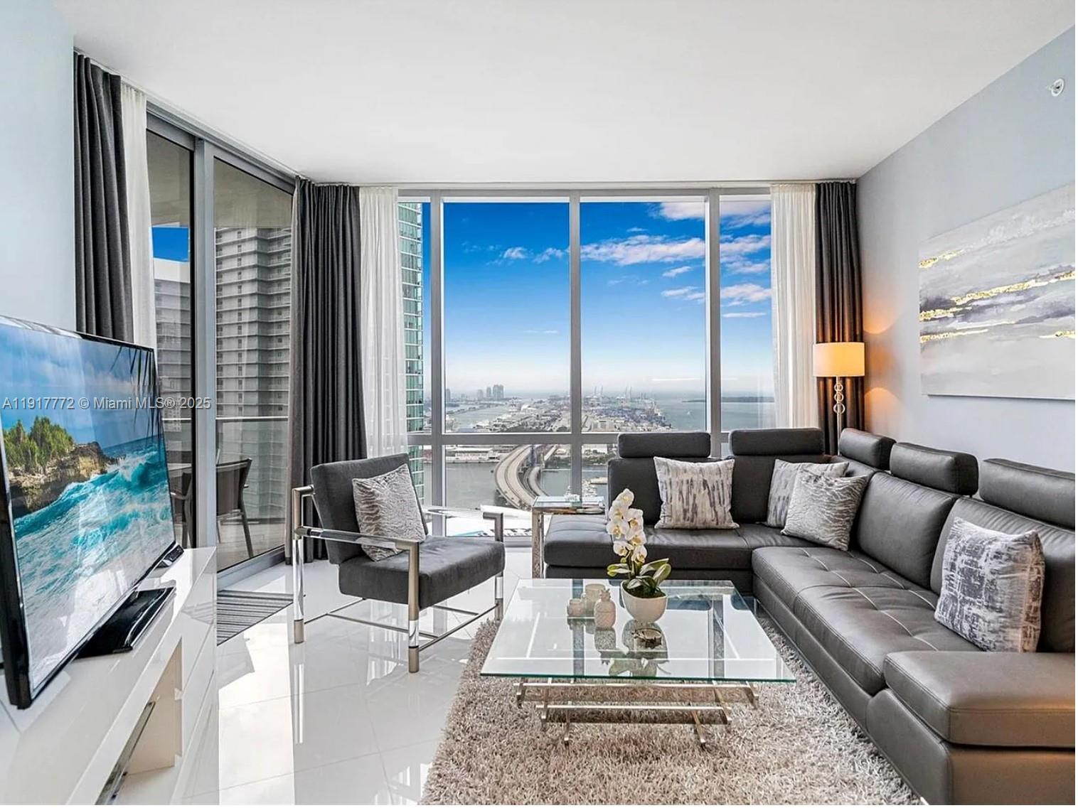 a living room with furniture and a flat screen tv