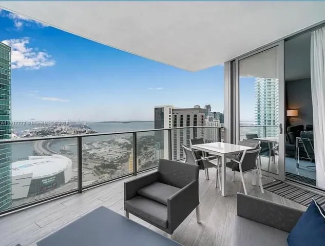 a living room with furniture and a floor to ceiling window