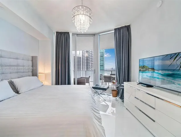 a bedroom with a large bed and a large window