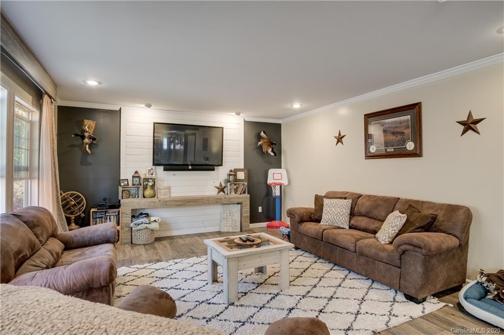 824 Dillsboro Road Sylva, NC 28779 - Photo 11 of 39 a living room with furniture and a flat screen tv