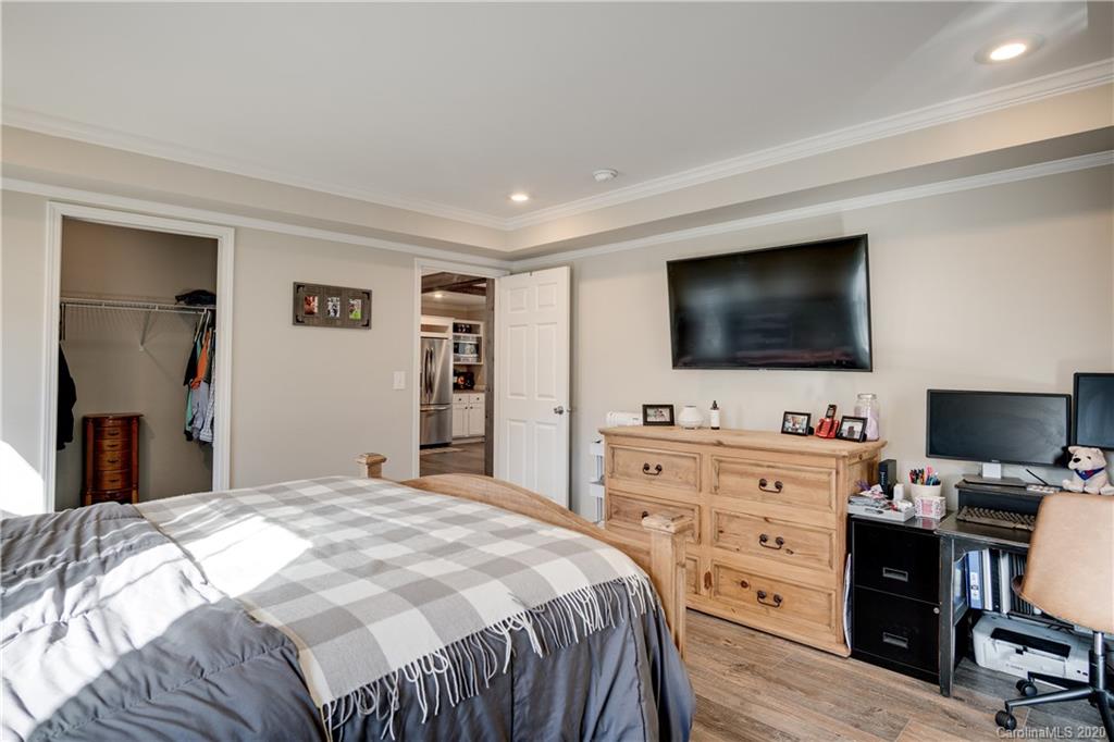 824 Dillsboro Road Sylva, NC 28779 - Photo 14 of 39 a bedroom with a bed and a flat screen tv