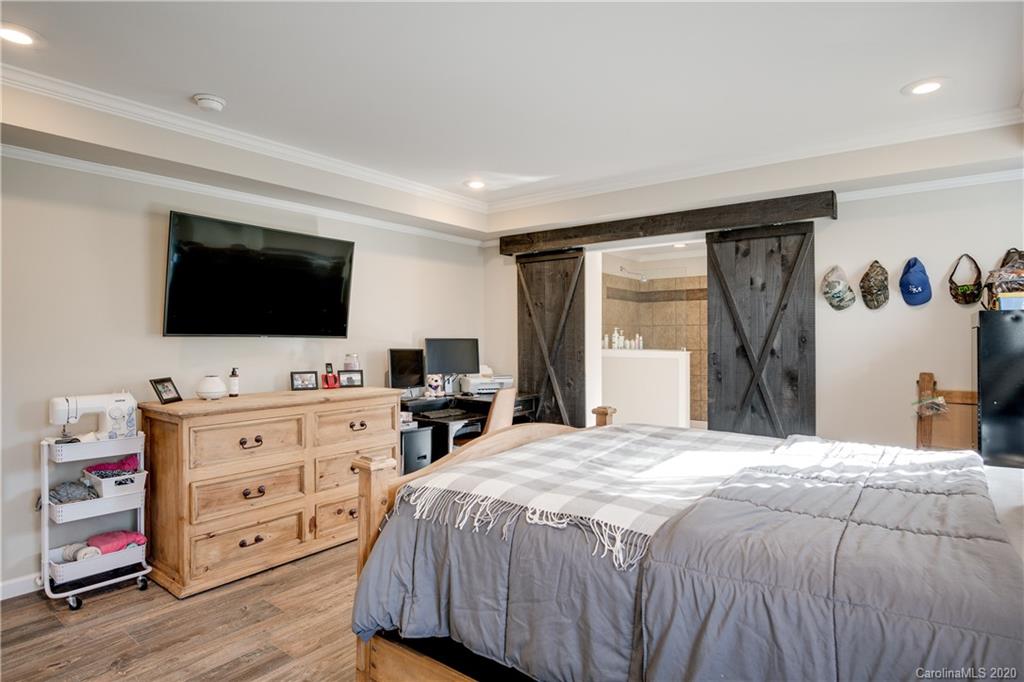 824 Dillsboro Road Sylva, NC 28779 - Photo 15 of 39 a bedroom with a bed and a flat screen tv