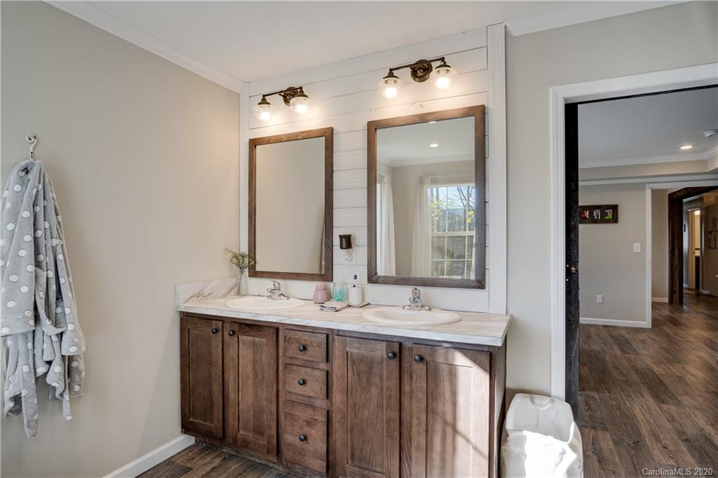 824 Dillsboro Road Sylva, NC 28779 - Photo 17 of 39 a bathroom with a double vanity sink and a mirror