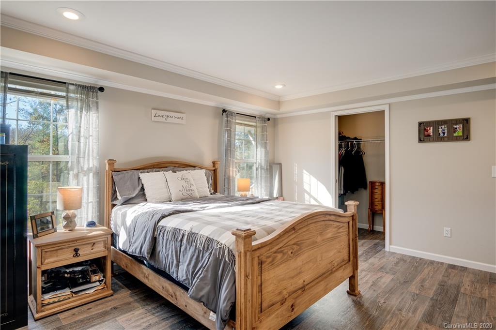 824 Dillsboro Road Sylva, NC 28779 - Photo 21 of 39 a bedroom with a bed and a mirror