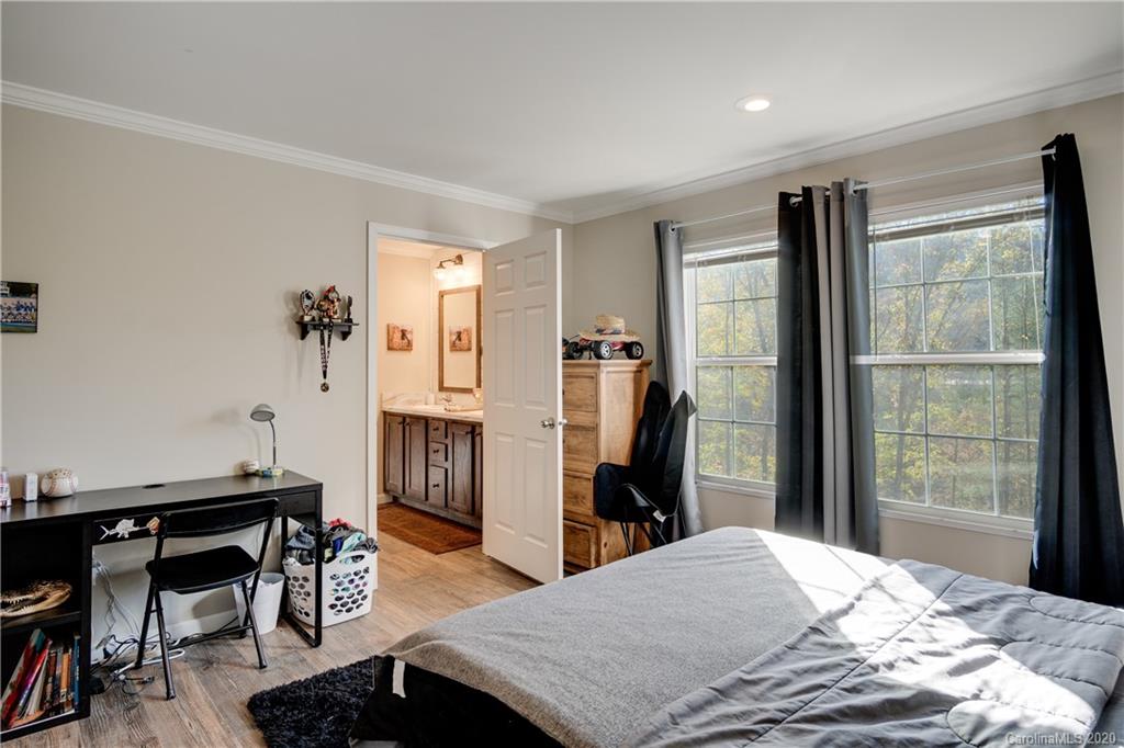 824 Dillsboro Road Sylva, NC 28779 - Photo 23 of 39 a bedroom with a bed and a table
