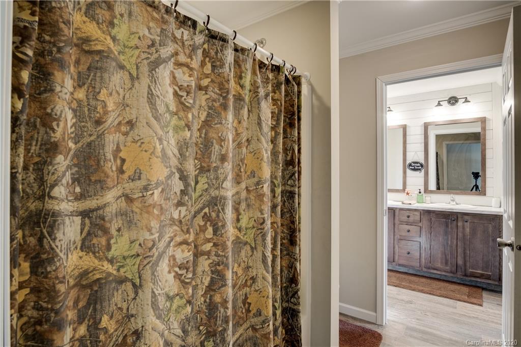 824 Dillsboro Road Sylva, NC 28779 - Photo 26 of 39 a bathroom with a shower curtain and a sink