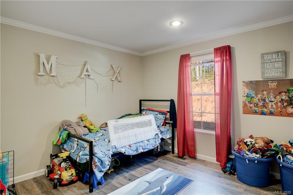 824 Dillsboro Road Sylva, NC 28779 - Photo 28 of 39 a bedroom with furniture toys and a window