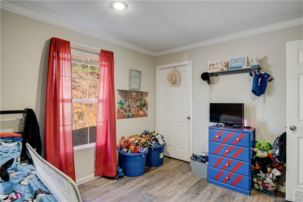 824 Dillsboro Road Sylva, NC 28779 - Photo 29 of 39 a living room with furniture and a flat screen tv