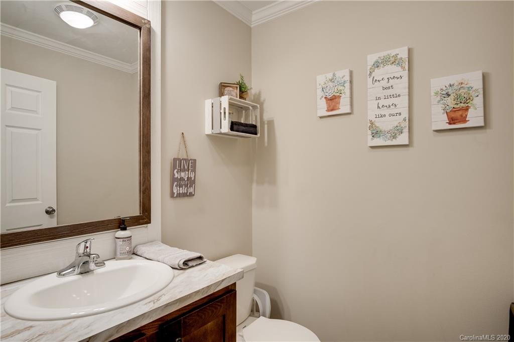 824 Dillsboro Road Sylva, NC 28779 - Photo 30 of 39 a bathroom with a sink mirror and toilet
