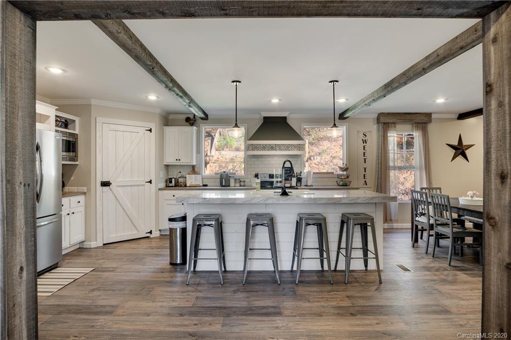 824 Dillsboro Road Sylva, NC 28779 - Photo 6 of 39 a large kitchen with a table and chairs