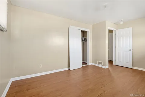 an empty room with closet area