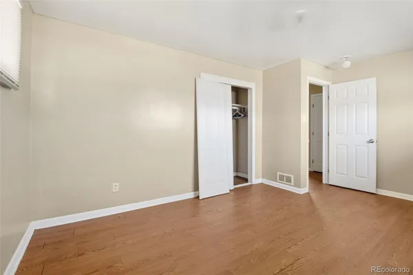 an empty room with closet area