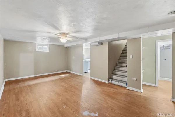 wooden floor in an empty room with stairs