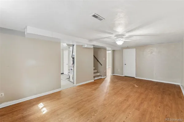 a view of an empty room with a ceiling fan